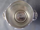a silver vase that is sitting on a table