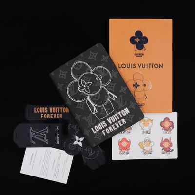 louis vuitton passport cover with stickers and stickers on a black background