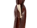 figurine of a woman with a hat and a cane on a marble base