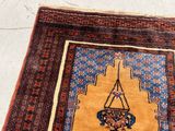 a rug with a hanging basket on it on the floor