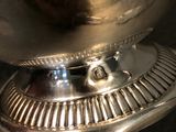 a silver bowl sitting on top of a table