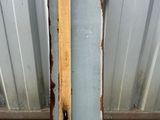an old metal door with a wooden handle on the side of a building