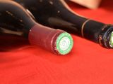 two bottles of wine sitting on a red table