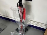 a vacuum that is sitting on the floor in the room
