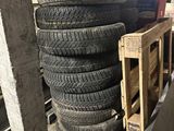 many tires stacked up on a pallet in a warehouse