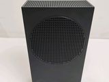 a close up of a black speaker on a white surface