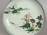 a plate with a painting on it on a table