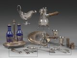 a silver plate and silverware on display on a table