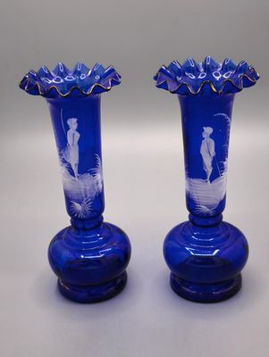 two blue vases that are sitting on a table
