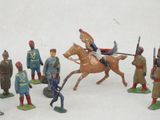 a lot of figurines of soldiers on a white surface