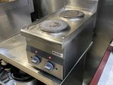 stainless steel counter top with two burners and a pot on it