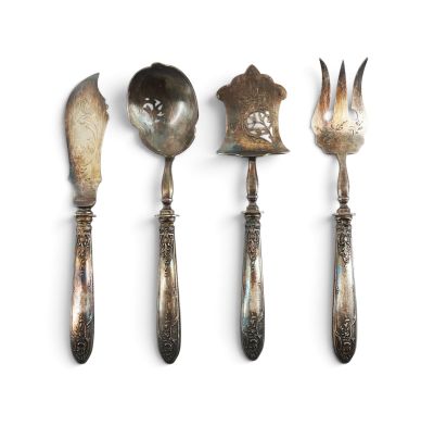 three spoons, a fork, and a spoon rest on a white surface