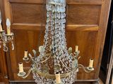 a glass chandelier hanging from a metal frame