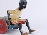a toy of a man sitting in a toy car