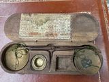 a small box with a clock inside of it on a table