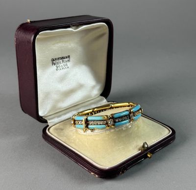 an image of a gold and turquoise bracelet in a case