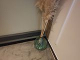 a vase with some flowers in it sitting on the floor