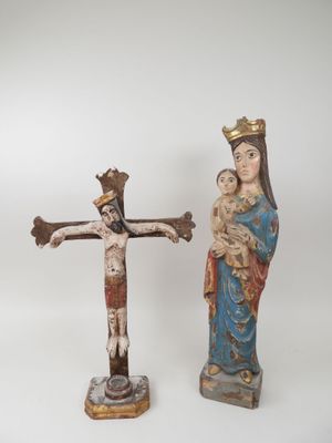 statue of jesus on the cross with a woman holding a child
