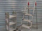 two ladders sitting next to each other in front of a garage door
