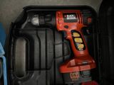 a cordless drill in a toolbox with other tools in it
