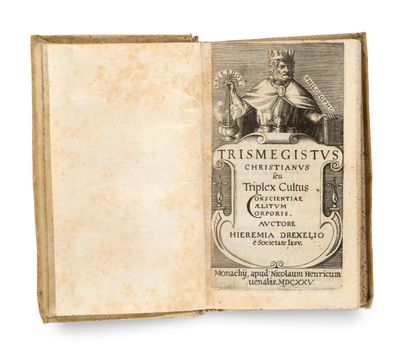 un vieux livre sur lequel figure l'image d'un homme coiffé d'une couronne, assis dessus