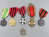 a group of medals including a star, a medal, and a cross