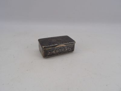 an old silver box sitting on top of a white surface