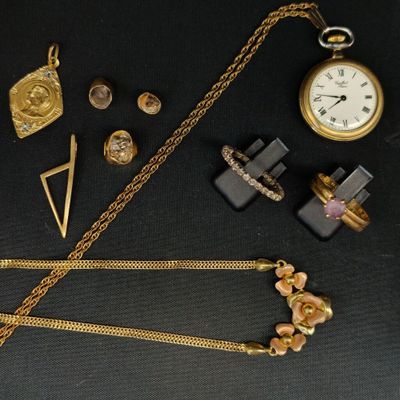 de nombreux bijoux en or posés sur une table noire