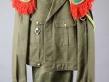 an army uniform with a green jacket and red feathers on it