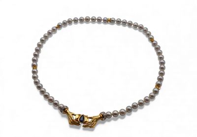 a close up of a beaded bracelet with a gold clasp