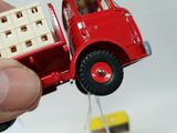 a red toy truck with a ladder attached to it ' s back