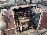 an old car that is sitting in a garage