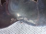 a silver spoon with a black handle on a table