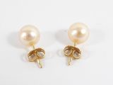 a pair of pearl and gold earrings on a white background