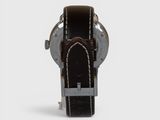 a close up of a watch on a white surface