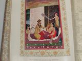 an open book with a picture of a woman sitting on a bed