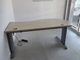 a desk in the corner of a room with a sliding glass door