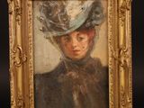 a painting of a woman with a hat on a easel