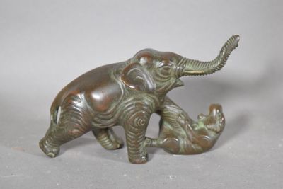 a statue of an elephant and a baby elephant on a table