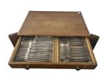 an image of a wooden box filled with silverware on top of a white background