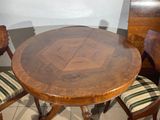 a wooden table with four chairs around it