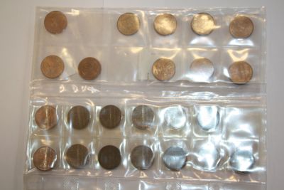 a lot of coins in a plastic bag on the table