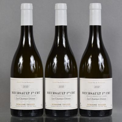 three bottles of wine are lined up on a table