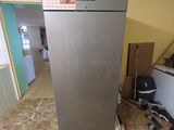 an image of a kitchen with a refrigerator in the middle of the floor