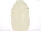 a white vase that has a design on it