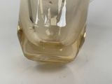 a glass vase that has a handle on it