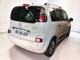 a picture of a small white car parked in a room