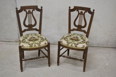 paire de chaises anciennes en bois avec des housses d'assise rembourrées à motifs floraux