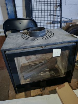 a stove that is sitting in the middle of a room