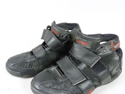 pair of black shoes with red accents on a white background